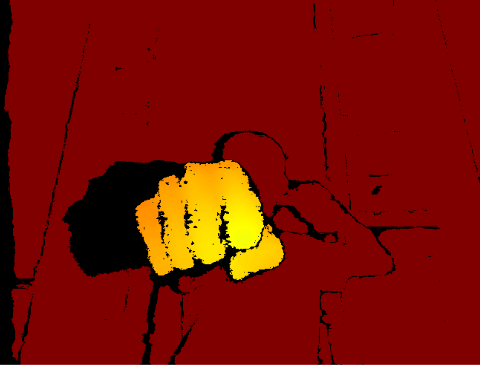 Depth image colorized with a heat colormap, a fist glowing in front